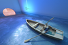 rowboat in a blue-lit room