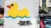 Hubs ducky logo spraypainted on a wall in downtown Palm Springs, by Codezart.